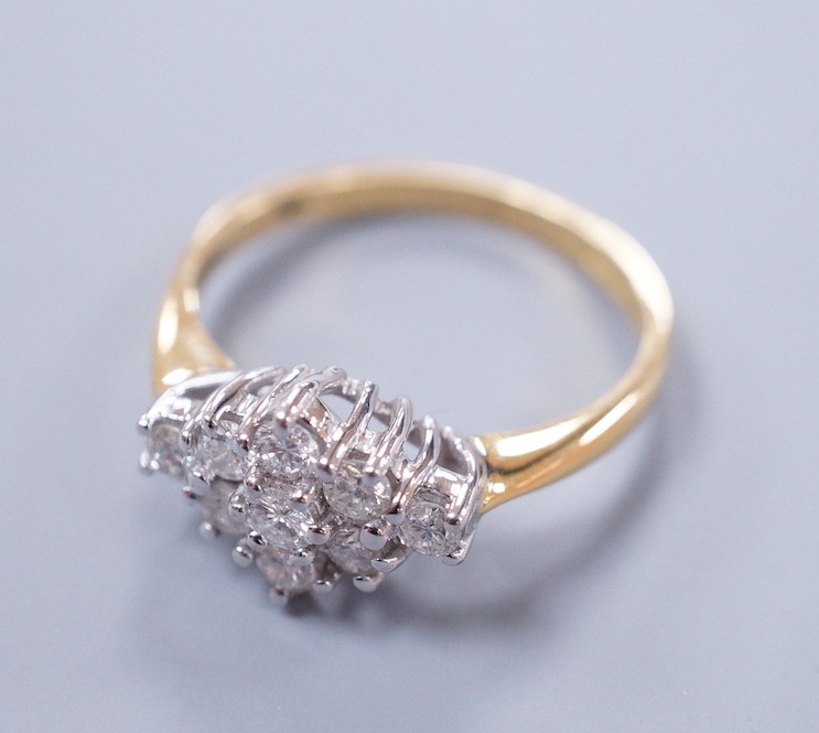 A modern 18ct gold and nine stone diamond set shaped cluster ring, size P, gross weight 4.3 grams
